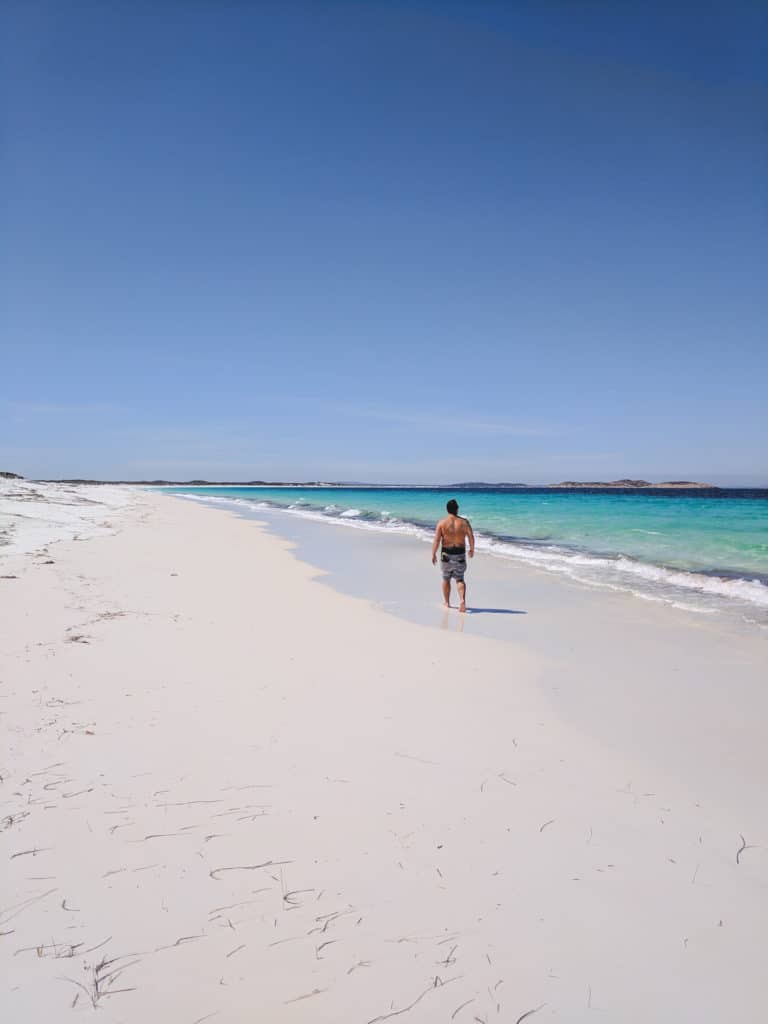Mike walking down the coastline of Rossiter Bay in Cape Le Grand National Park